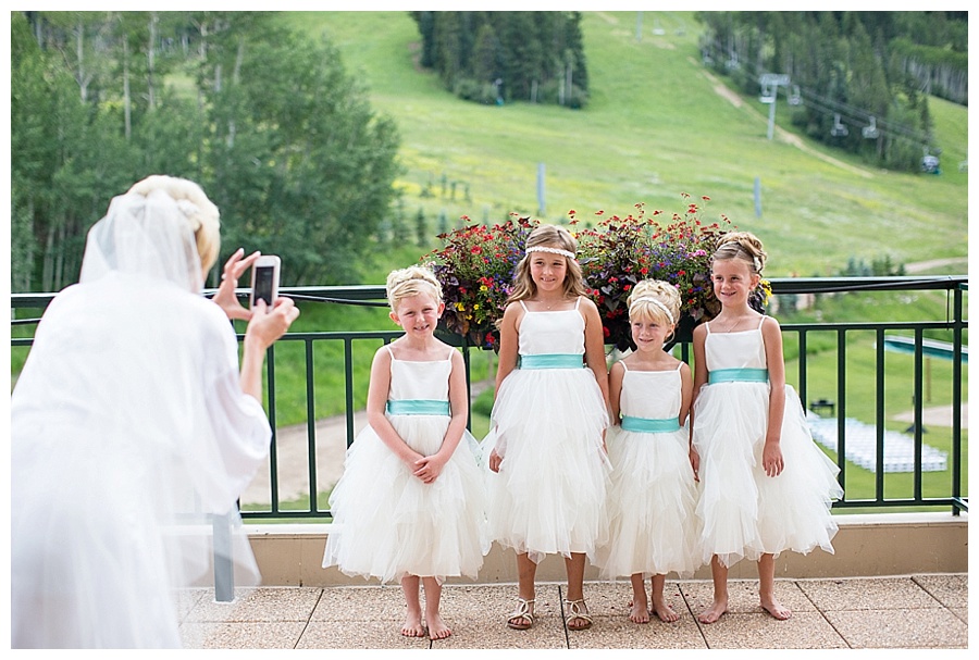 14 Bride taking photos of flower girls in Beaver Creek
