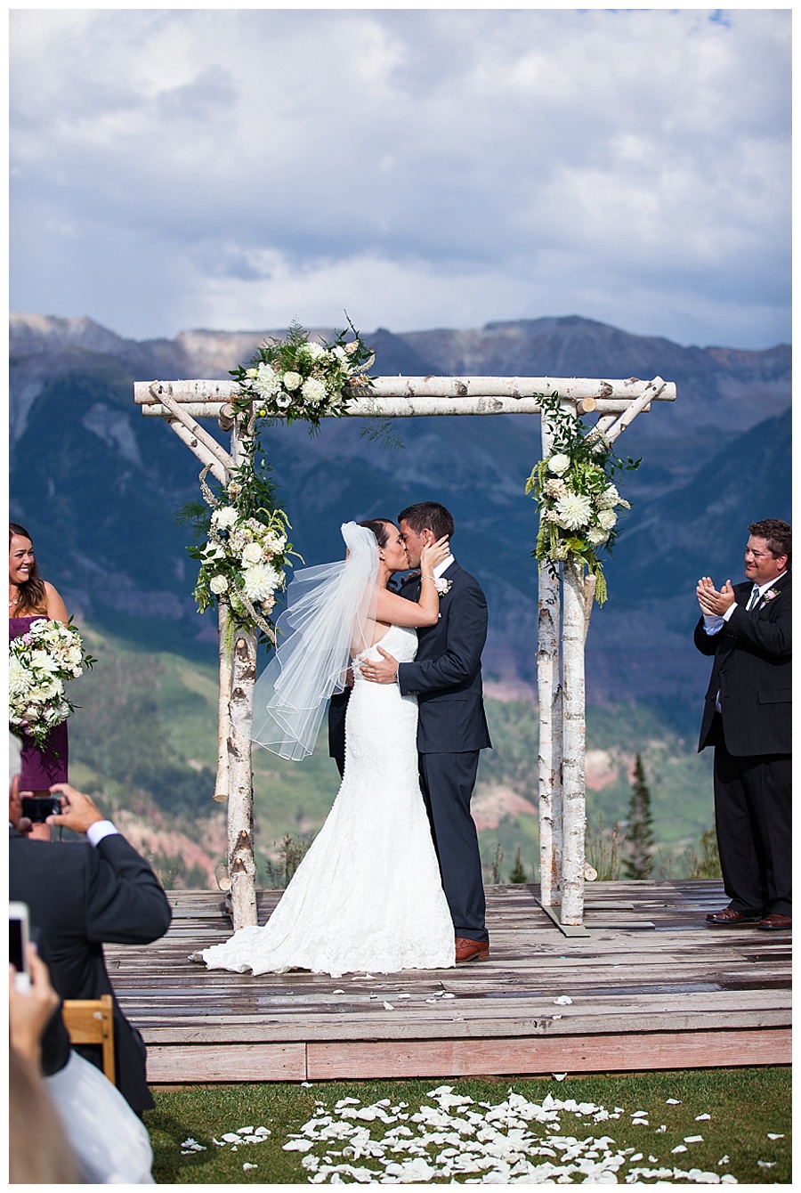 16 Ceremony Kiss at San Sophia Overlook in Telluride rainy romantic wedding