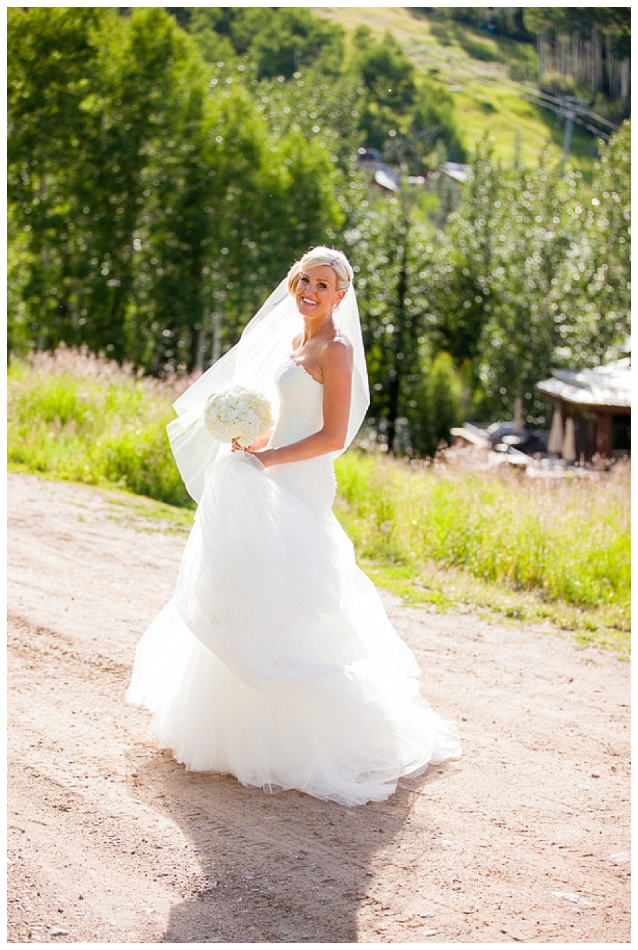 26 Bride on dirt road in Beaver Creek Park Hyatt wedding