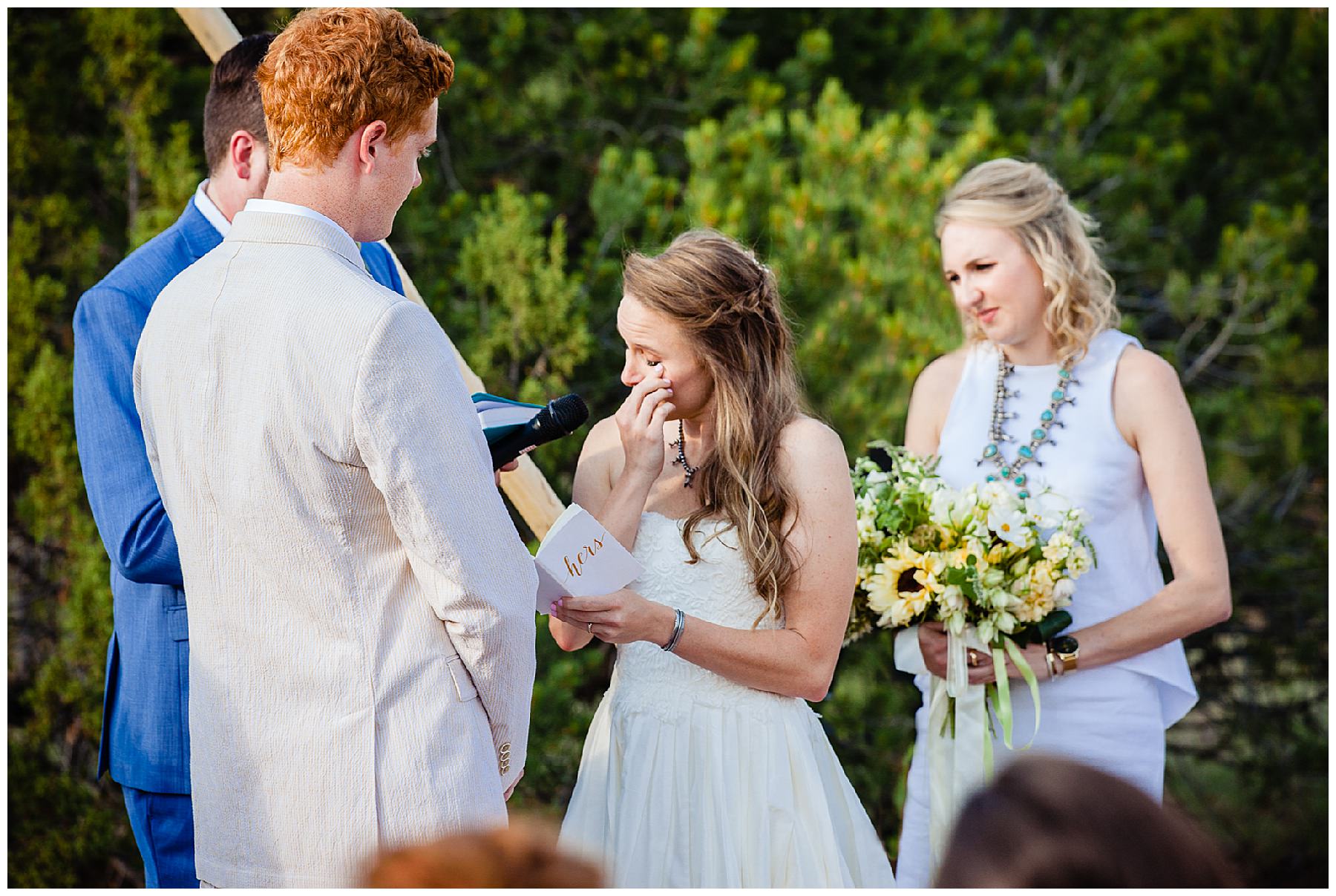 Bride crying while saying vows during outdoor wedding ceremony